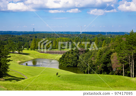 Blue sky golf course, view of a difficult downhill course with ponds and numerous bumps (Kisarazu City, Chiba Prefecture) 97417095