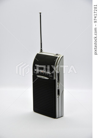 Portable radio receiver on a white background. Small player close-up. A battery-powered radio. 97417281