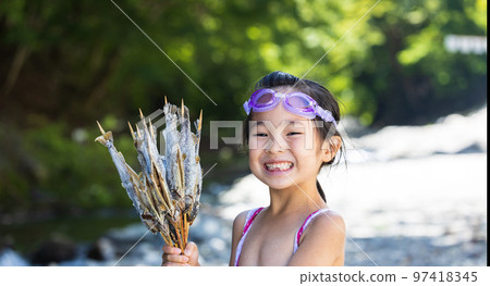 Children enjoying playing in the river 97418345
