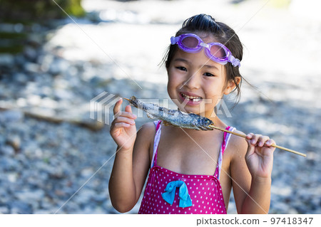 Children enjoying playing in the river Children enjoying playing in the river 97418347