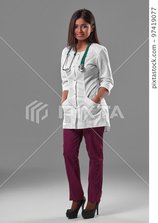 Beautiful young doctor in a medical robe with a stethoscope Beautiful young doctor in a medical robe with a stethoscope 97419077