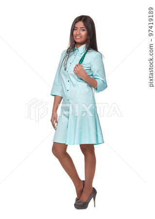 Adorable indian female doctor nurse with stethoscope in aquamarine dress isolated on white background 97419189