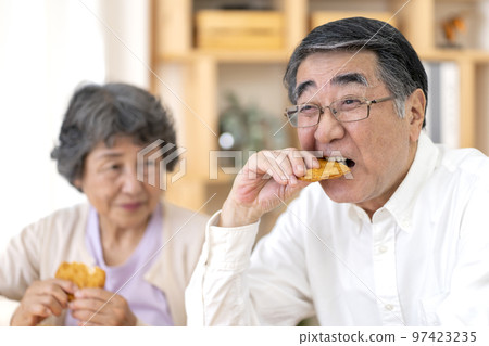 Senior man who has difficulty eating hard food Senior man who has difficulty eating hard food 97423235