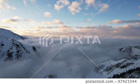 Flying among the ocean of clouds in the mountains 97423344