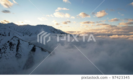 Flying among the ocean of clouds in the mountains 97423345