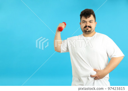 Concept of weight loss, young fat man on blue background 97423815