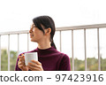 Woman relaxing on hotel terrace 97423916