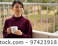 Woman relaxing on hotel terrace 97423918