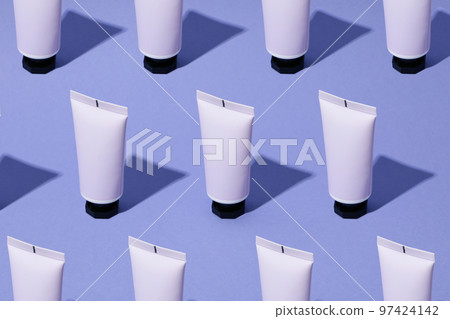 Blank tube of cosmetic on violet background, space for text 97424142