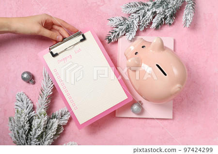 Concept of Christmas finance with piggy bank, top view Concept of Christmas finance with piggy bank, top view 97424299