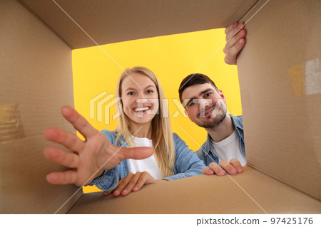 Concept of delivery, surprise, gift, young people opened a cardboard box Concept of delivery, surprise, gift, young people opened a cardboard box 97425176
