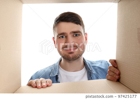 Concept of delivery, gift, surprise, young man and cardboard box, isolated on white background Concept of delivery, gift, surprise, young man and cardboard box, isolated on white background 97425177