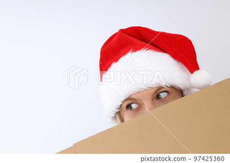 Concept of Happy New Year gift, woman in santa hat and cardboard box texture Concept of Happy New Year gift, woman in santa hat and cardboard box texture 97425360