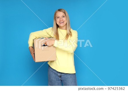 Concept of delivery, surprise, gift, young woman and cardboard box Concept of delivery, surprise, gift, young woman and cardboard box 97425362