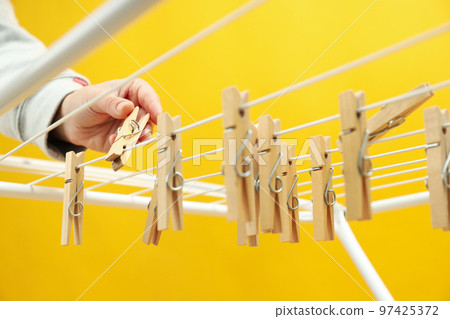 Clothespins hanging on drying rack, close up 97425372
