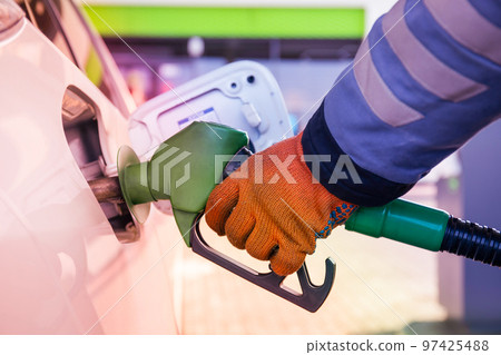 Refueling the car at a gas station fuel pump 97425488