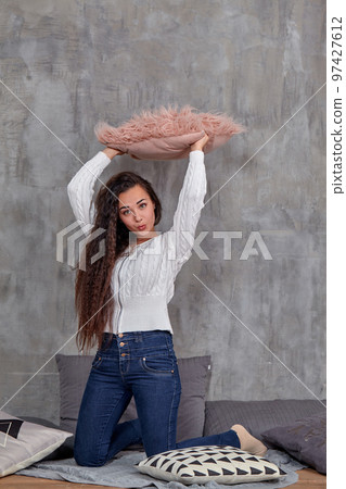 Young pretty attractive brunette woman posing before camera sitting on the floor Young pretty attractive brunette woman posing before camera sitting on the floor 97427612