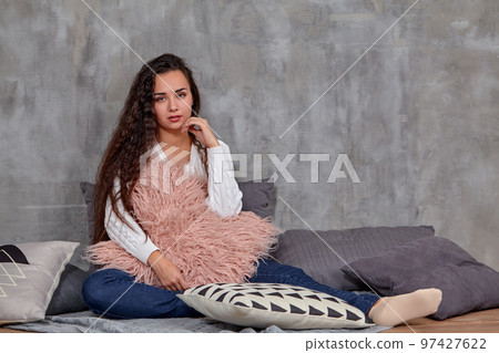 Young pretty attractive brunette woman posing before camera sitting on the floor 97427622