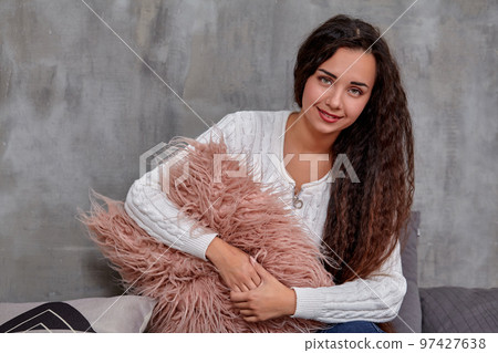 Young pretty attractive brunette woman posing before camera sitting on the floor Young pretty attractive brunette woman posing before camera sitting on the floor 97427638