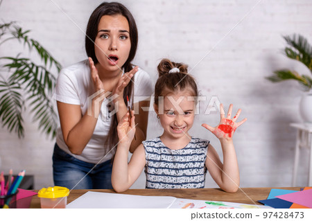 Happy family. Mother and daughter together paint. Happy family. Mother and daughter together paint. 97428473