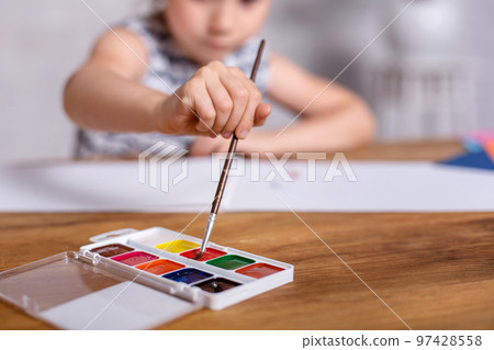 Education, school, art and painting concept - Little girl draws paints Education, school, art and painting concept - Little girl draws paints 97428558