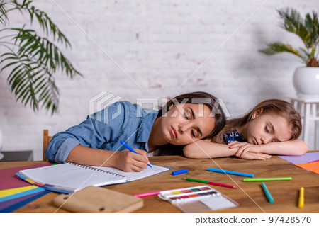 Mother becoming frustrated with daughter whilst doing homework sitting at the table at home in learning difficulties homework. Mother becoming frustrated with daughter whilst doing homework sitting at the table at home in learning difficulties homework. 97428570