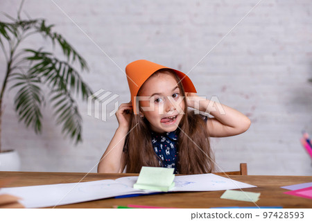 Cute little girl with the colored paper 97428593