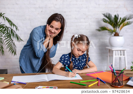 Happy family mother and daughter together draw with markers. 97428634
