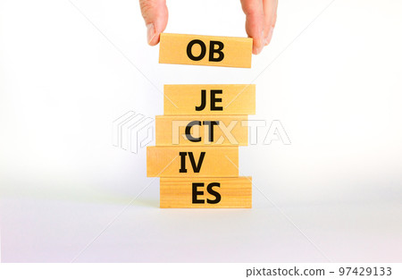 Objectives symbol. Wooden blocks stacking as step stair on beautiful white background, copy space. The word 'objectives'. Businessman hand. Business and objectives concept. 97429133