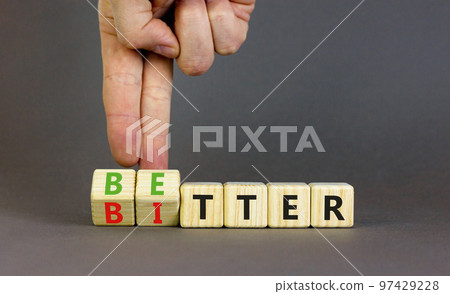 Better or bitter symbol. Concept word Better and Bitter on wooden cubes. Businessman hand. Beautiful grey table grey background. Business and better or bitter concept. Copy space. Better or bitter symbol. Concept word Better and Bitter on wooden cubes. Businessman hand. Beautiful grey table grey background. Business and better or bitter concept. Copy space. 97429228