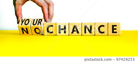 Your or no chance symbol. Businessman turns wooden cubes and changes words 'no chance' to 'your chance'. Beautiful white background, copy space. Business and your or no chance concept. 97429253