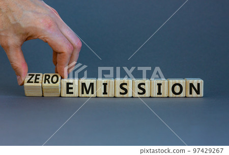 Zero emission symbol. Businessman turns wooden cubes and changes words Emission to Zero emission. Beautiful grey background. Business, ecological and zero emission concept. Copy space. Zero emission symbol. Businessman turns wooden cubes and changes words Emission to Zero emission. Beautiful grey background. Business, ecological and zero emission concept. Copy space. 97429267