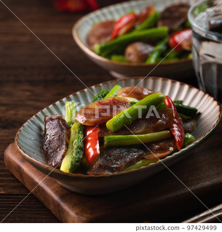 Delicious spicy homemade stir-fried Chinese smoked sausage with asparagus. 97429499