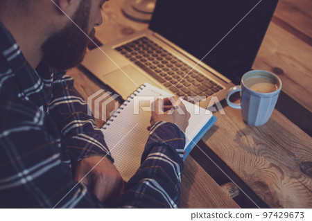 Cropped image of casual business man or freelancer planning his Cropped image of casual business man or freelancer planning his 97429673