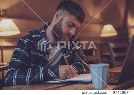 Casual business man or freelancer planning his work on notebook, 97429674