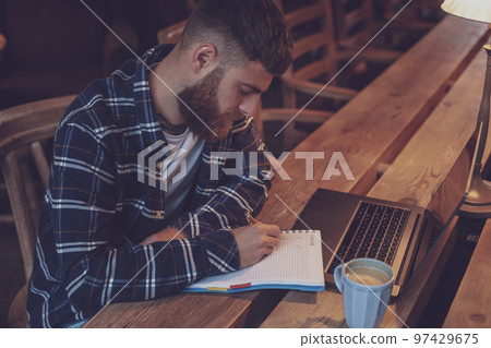 Casual business man or freelancer planning his work on notebook, Casual business man or freelancer planning his work on notebook, 97429675