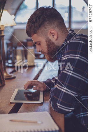 Freelancer dressed in casual outfit focus on reading news and lo 97429747
