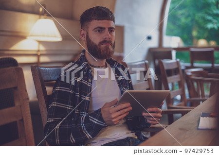 Freelancer dressed in casual outfit focus on reading news and lo 97429753