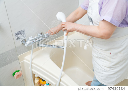 [Middle housewife cleaning the bath, showering] 97430184