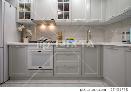 New light grey modern well designed kitchen interior, front view New light grey modern well designed kitchen interior, front view 97431758