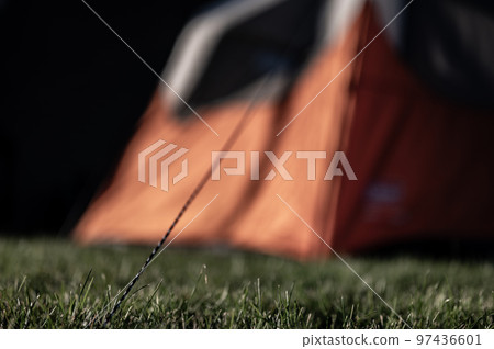 Selective focus on tent support rope leading up to the canvas to secure in-place Selective focus on tent support rope leading up to the canvas to secure in-place 97436601