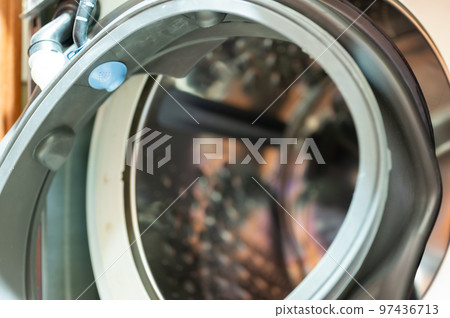 Selective Focus on the gasket mount of a front loading washing machine being serviced 97436713