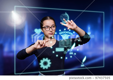 Teenage student girl pointing at abstract glowing monitor 97437505