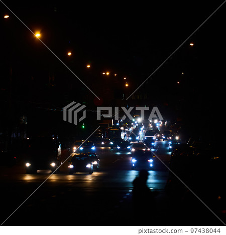 Kyiv, Ukraine - December 16, 2022: Blackout in the Ukrainian capital Kyiv. Capital streets without street lighting. Only the lights of passing cars are visible 97438044