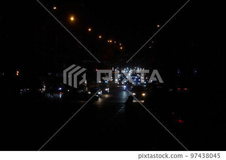 Kyiv, Ukraine - December 16, 2022: Blackout in the Ukrainian capital Kyiv. Capital streets without street lighting. Only the lights of passing cars are visible 97438045