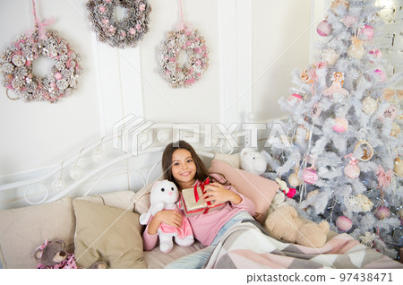 delivery christmas gifts. happy new year. happy little girl celebrate winter holiday. Happy New Year to you. christmas time. Cute little child girl with xmas present. morning before Xmas 97438471