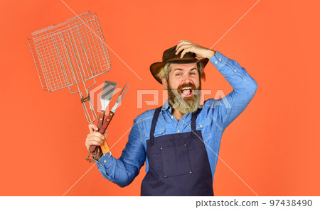 Picnic and barbecue. Steak and barbecue. Barbecue. Grilling food. American picnic. Family tradition. Cooking meat. Spring season. Bearded farmer wear hat and apron for barbecue. Roasting meat Picnic and barbecue. Steak and barbecue. Barbecue. Grilling food. American picnic. Family tradition. Cooking meat. Spring season. Bearded farmer wear hat and apron for barbecue. Roasting meat 97438490