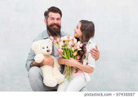 Wishing happy anniversary. Happy family celebrate anniversary. Father and daughter hold tulips and toy. Fathers day. Womens day. Birthday anniversary. Holiday celebration. International childrens day 97438887