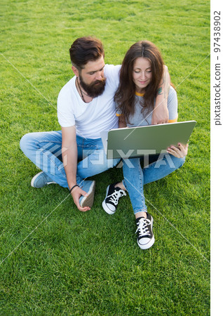 Laptop with internet connection. Bearded man and sexy girl use laptop outdoors. Laptop computer. Notebook and pc. Laptop technology. Online access. Internet surfing. Modern life. Social networking Laptop with internet connection. Bearded man and sexy girl use laptop outdoors. Laptop computer. Notebook and pc. Laptop technology. Online access. Internet surfing. Modern life. Social networking 97438902