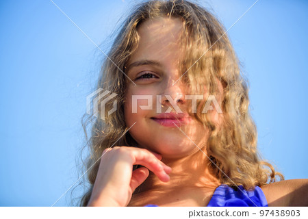 Uv filter sunscreen. Take care. Summer care. Sunscreen concept. Child pleased with warm sunlight looks relaxed blue sky background. Take care skin put sunscreen cosmetics. Girl kid relaxing outdoors Uv filter sunscreen. Take care. Summer care. Sunscreen concept. Child pleased with warm sunlight looks relaxed blue sky background. Take care skin put sunscreen cosmetics. Girl kid relaxing outdoors 97438903